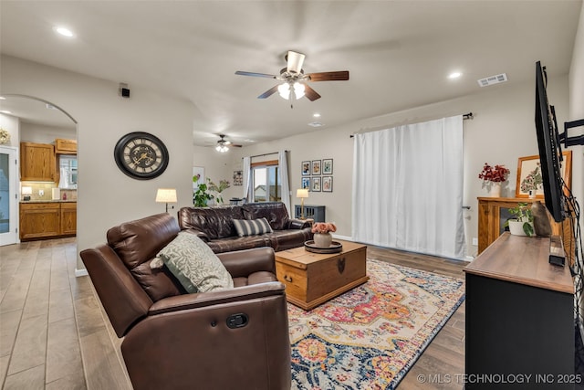 living room featuring ceiling fan and light wood-type flooring