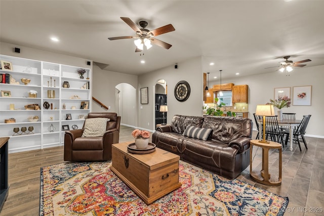 living room featuring hardwood / wood-style floors and ceiling fan