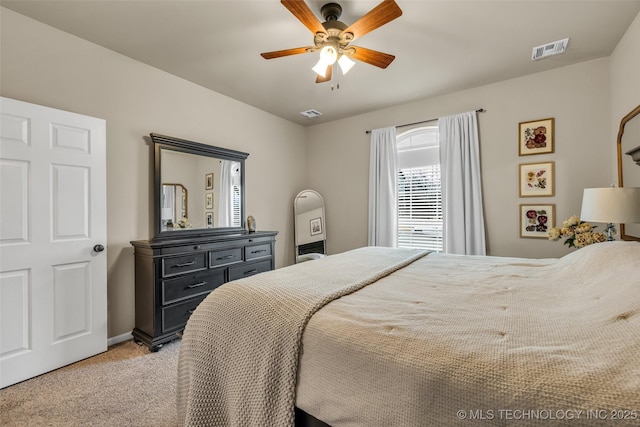 bedroom with ceiling fan and light colored carpet