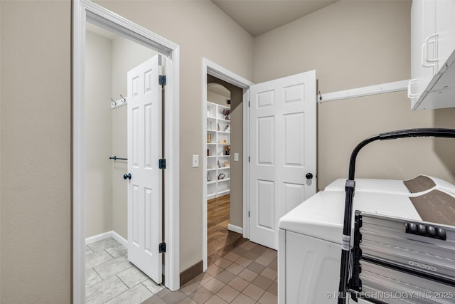 clothes washing area with light tile patterned floors