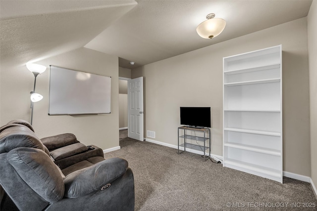 carpeted living room featuring built in features and a textured ceiling