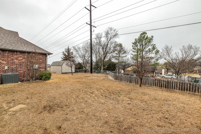 view of yard with cooling unit and a shed