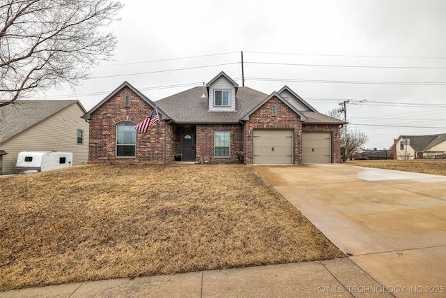 view of front of property with a garage and a front yard