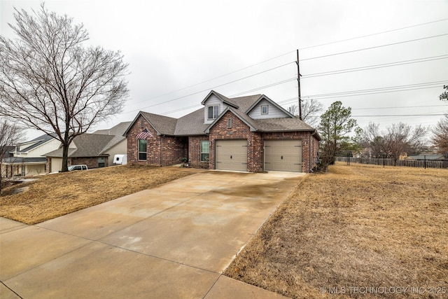 view of front of property featuring a garage and a front yard