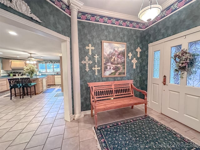 entryway with wallpapered walls, ceiling fan, light tile patterned floors, and crown molding