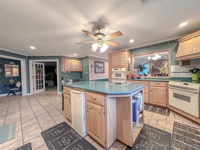 kitchen with white electric range, a kitchen island, light brown cabinets, and wallpapered walls