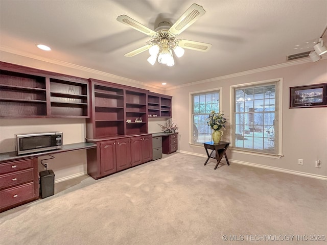 office with light carpet, baseboards, visible vents, ornamental molding, and built in desk