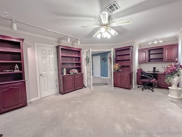 interior space with light carpet, a ceiling fan, visible vents, rail lighting, and crown molding