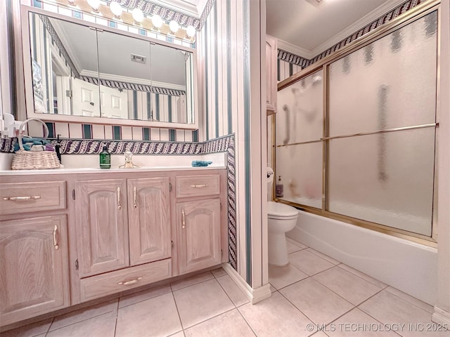 bathroom featuring shower / bath combination with glass door, toilet, ornamental molding, vanity, and tile patterned flooring