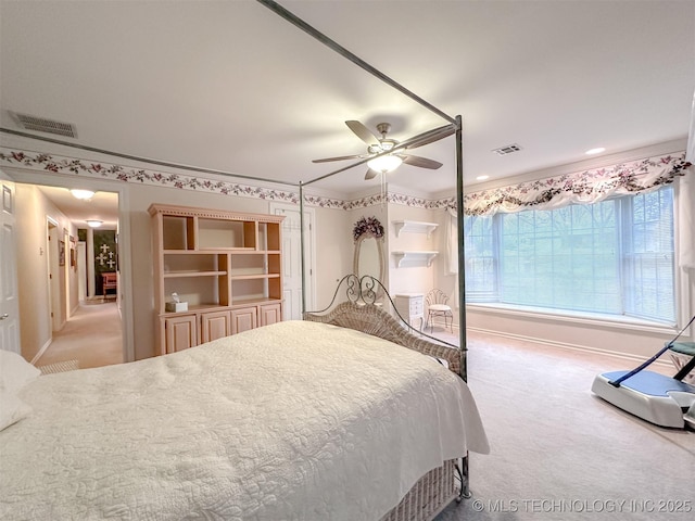 bedroom featuring baseboards, visible vents, a ceiling fan, and light colored carpet