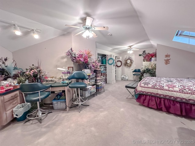 bedroom featuring lofted ceiling, rail lighting, ceiling fan, and light carpet