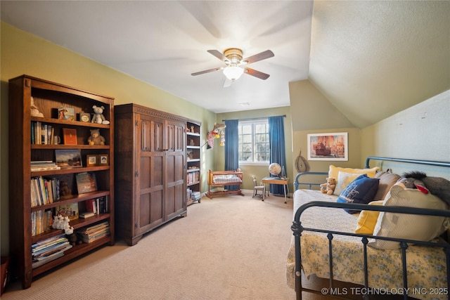 sitting room featuring ceiling fan, lofted ceiling, and carpet