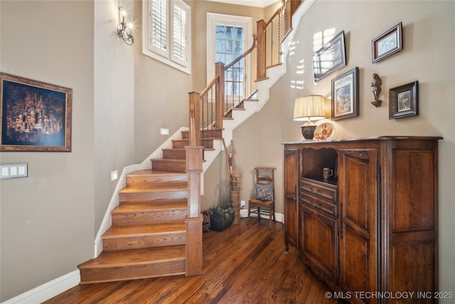 stairs featuring hardwood / wood-style floors