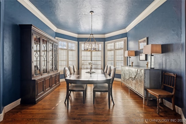 dining room featuring ornamental molding, dark hardwood / wood-style floors, a notable chandelier, and a textured ceiling