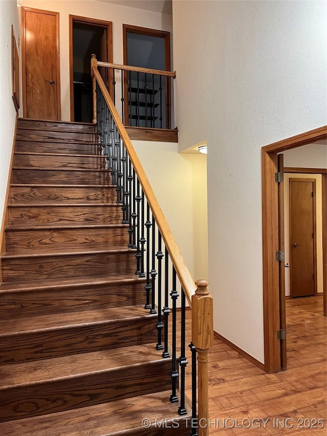 stairway featuring hardwood / wood-style flooring