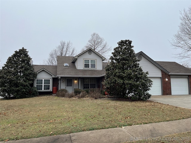 view of property featuring a garage and a front lawn