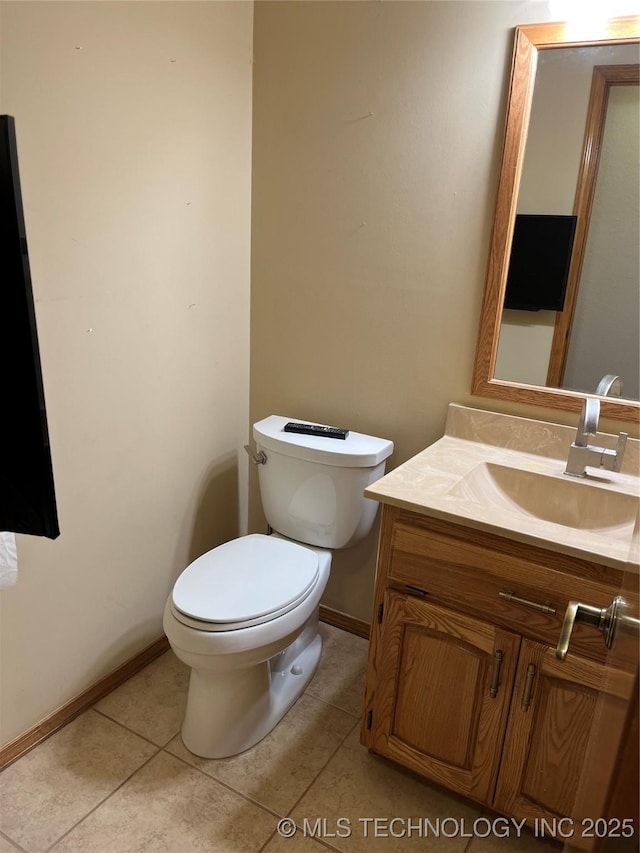 bathroom with vanity, toilet, and tile patterned flooring