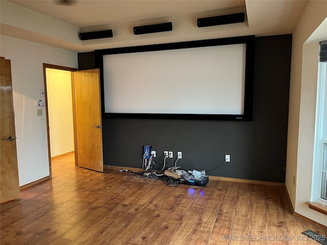 home theater room with wood-type flooring