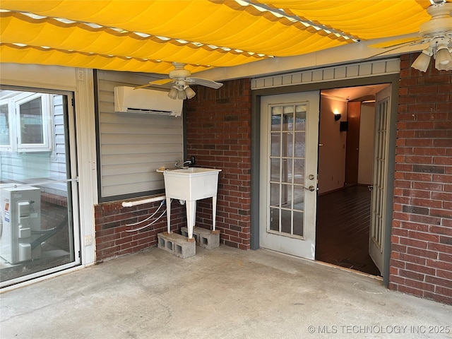 view of patio with a wall unit AC