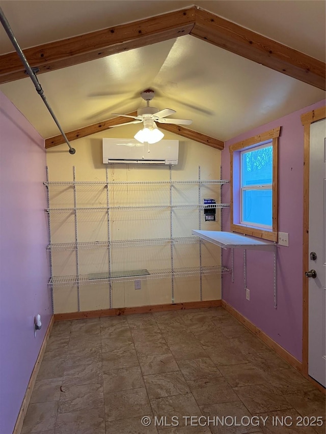 kitchen with vaulted ceiling, a wall unit AC, and ceiling fan