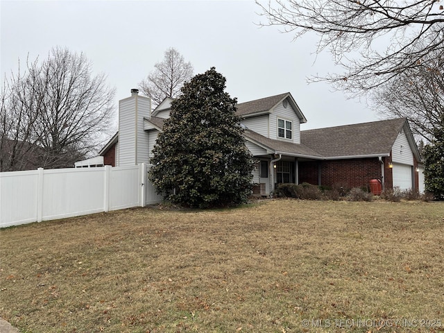 view of side of property with a garage and a lawn