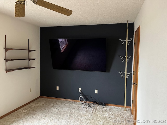 unfurnished room with ceiling fan, a textured ceiling, and carpet flooring