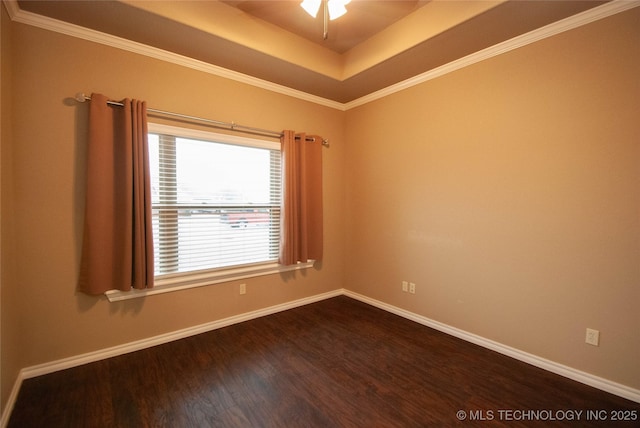 unfurnished room featuring a raised ceiling, wood-type flooring, ornamental molding, and ceiling fan