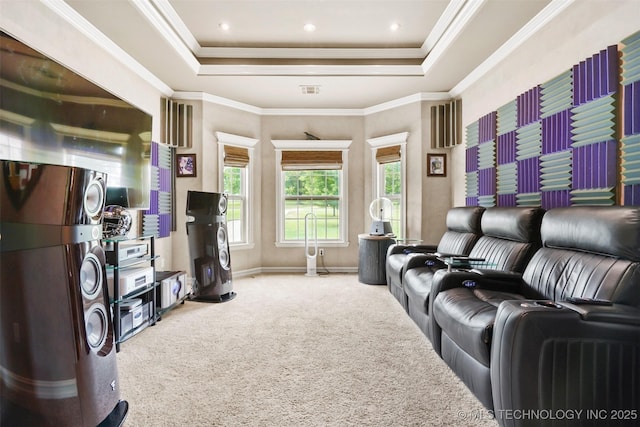 home theater with ornamental molding, carpet flooring, and a tray ceiling