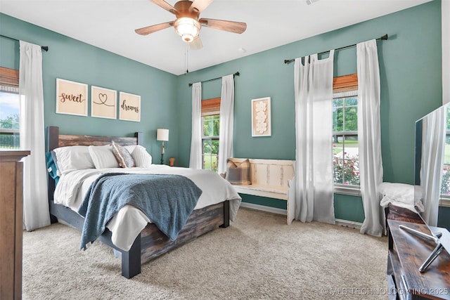 bedroom with multiple windows, carpet, and ceiling fan