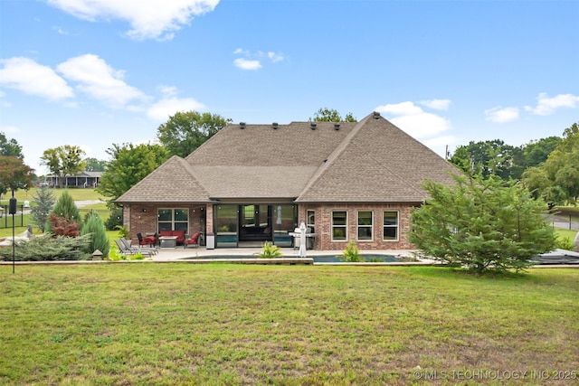 back of house featuring a yard and a patio