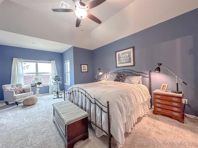 carpeted bedroom with ceiling fan and vaulted ceiling