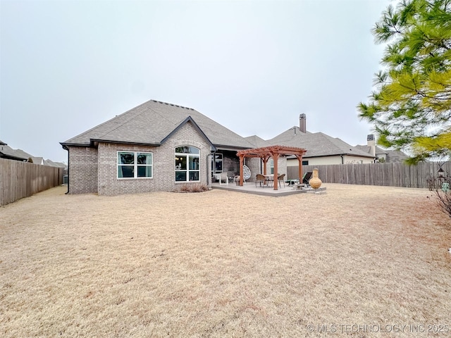 back of property featuring a patio area and a pergola