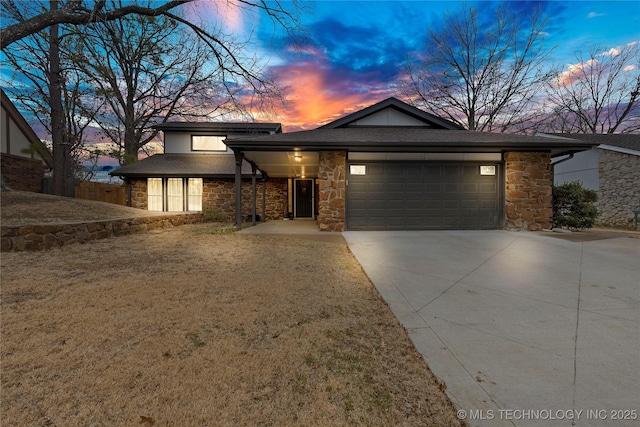 view of front of home with a garage and a yard