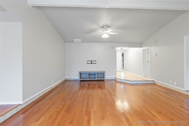 unfurnished living room featuring ceiling fan, wood-type flooring, and a textured ceiling