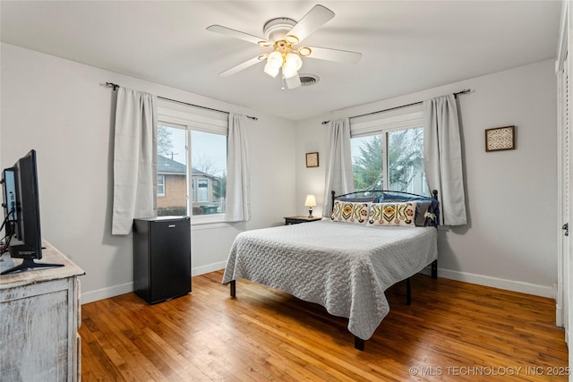 bedroom featuring wood-type flooring and ceiling fan