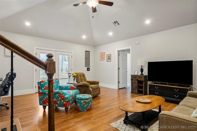 living room featuring ceiling fan, vaulted ceiling, and light hardwood / wood-style flooring