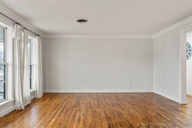 unfurnished room with hardwood / wood-style flooring and crown molding