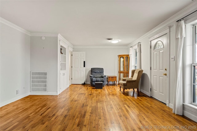 sitting room featuring crown molding, light hardwood / wood-style floors, and a healthy amount of sunlight