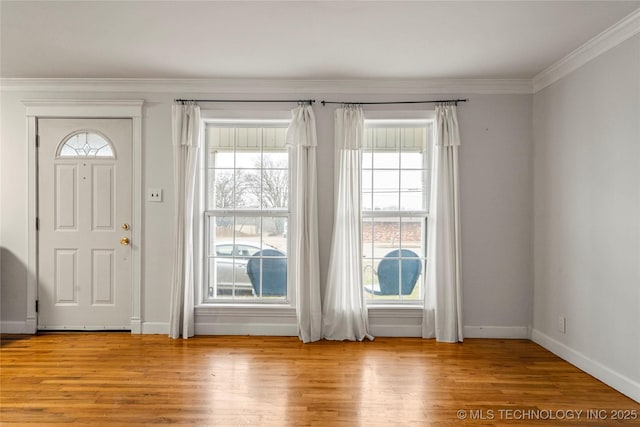 entryway with crown molding and light hardwood / wood-style floors