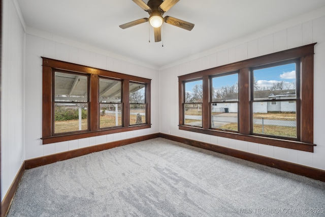 spare room with carpet floors and ceiling fan