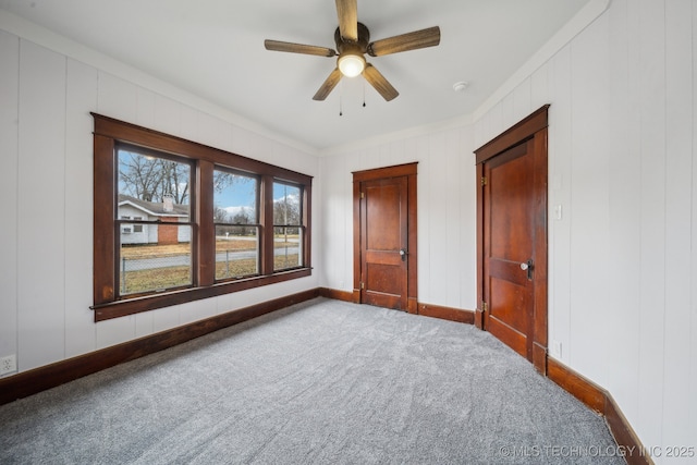 unfurnished bedroom featuring ceiling fan and carpet flooring