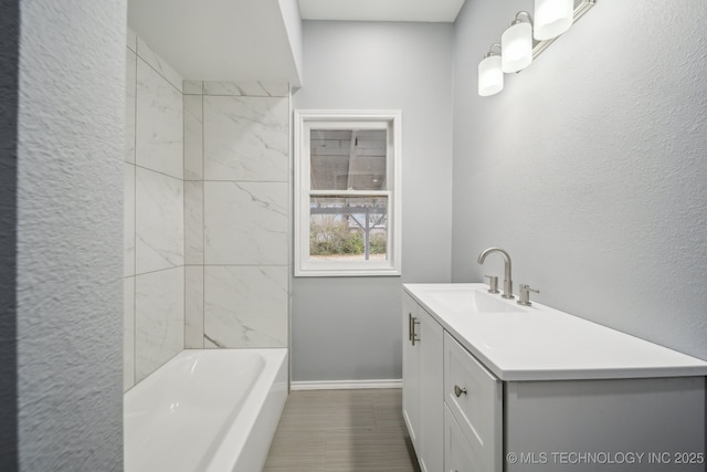 bathroom with vanity and tiled shower / bath