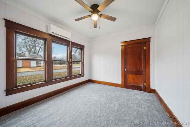 unfurnished room featuring ceiling fan, a wall mounted air conditioner, carpet flooring, and ornamental molding