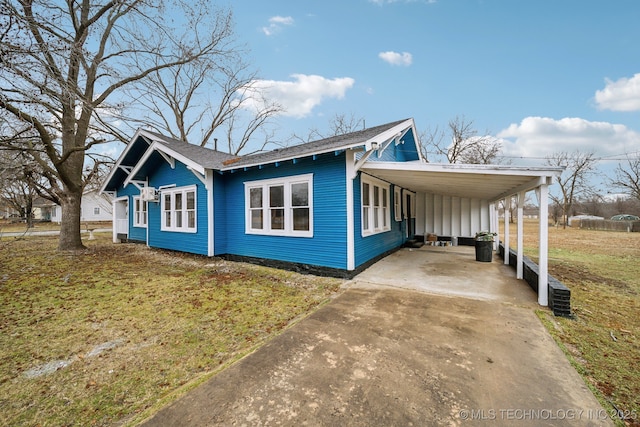 view of property exterior with a carport and a lawn