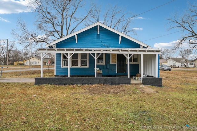 bungalow-style house with a front lawn and a porch