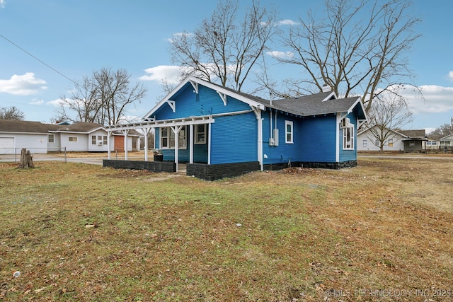 rear view of house with a yard