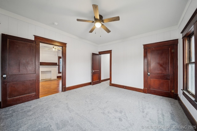 unfurnished bedroom with crown molding, ceiling fan, and carpet floors