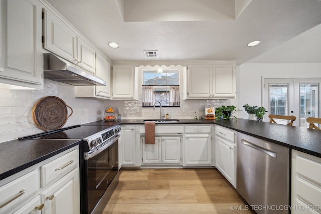 kitchen with sink, appliances with stainless steel finishes, white cabinetry, light hardwood / wood-style floors, and french doors