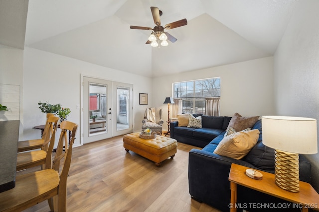 living room featuring french doors, ceiling fan, lofted ceiling, and light hardwood / wood-style flooring