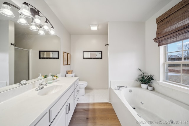 full bathroom featuring toilet, vanity, shower with separate bathtub, and hardwood / wood-style floors